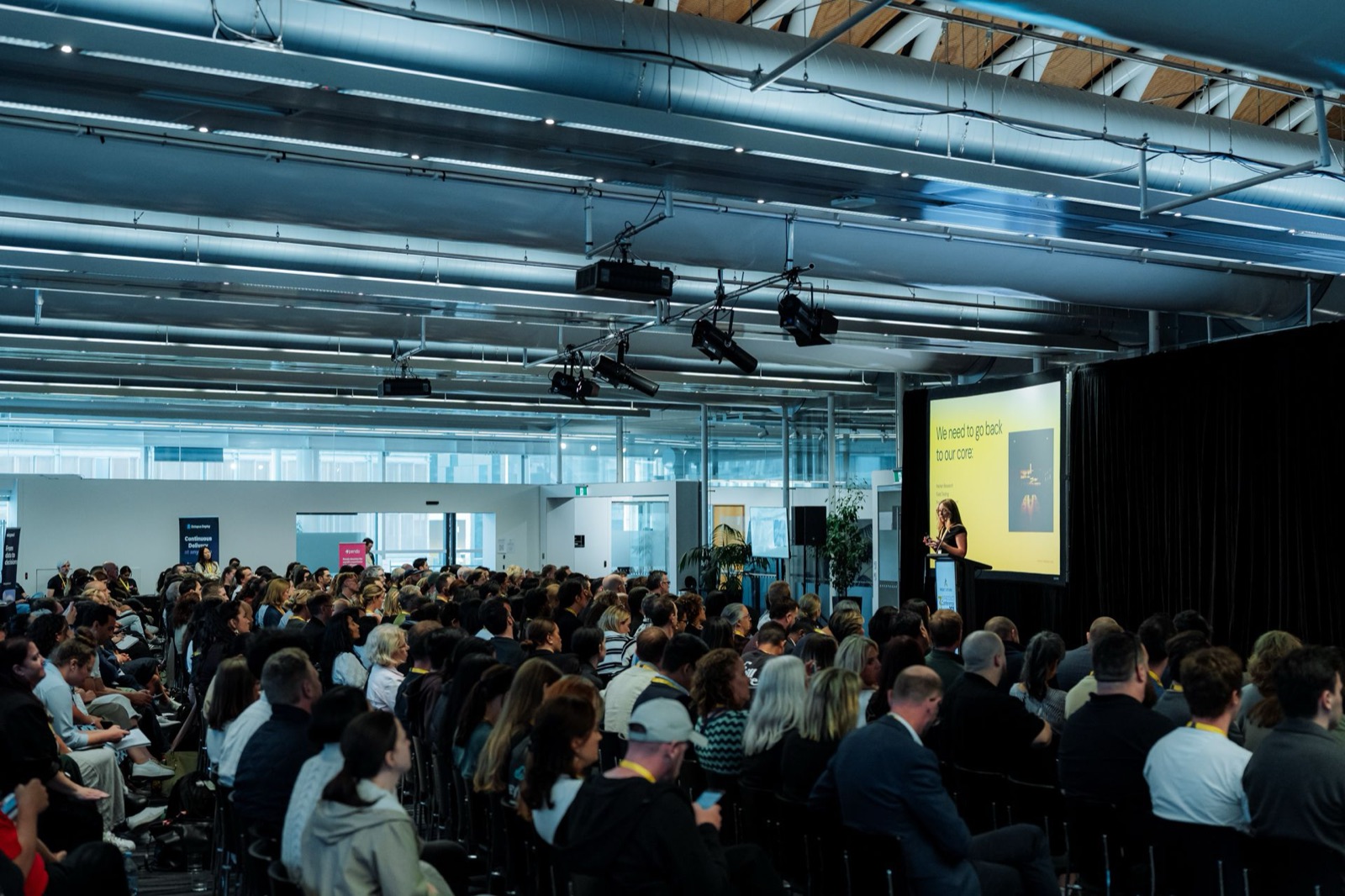 Corinna giving a keynote to a packed room at Product Aotearoa